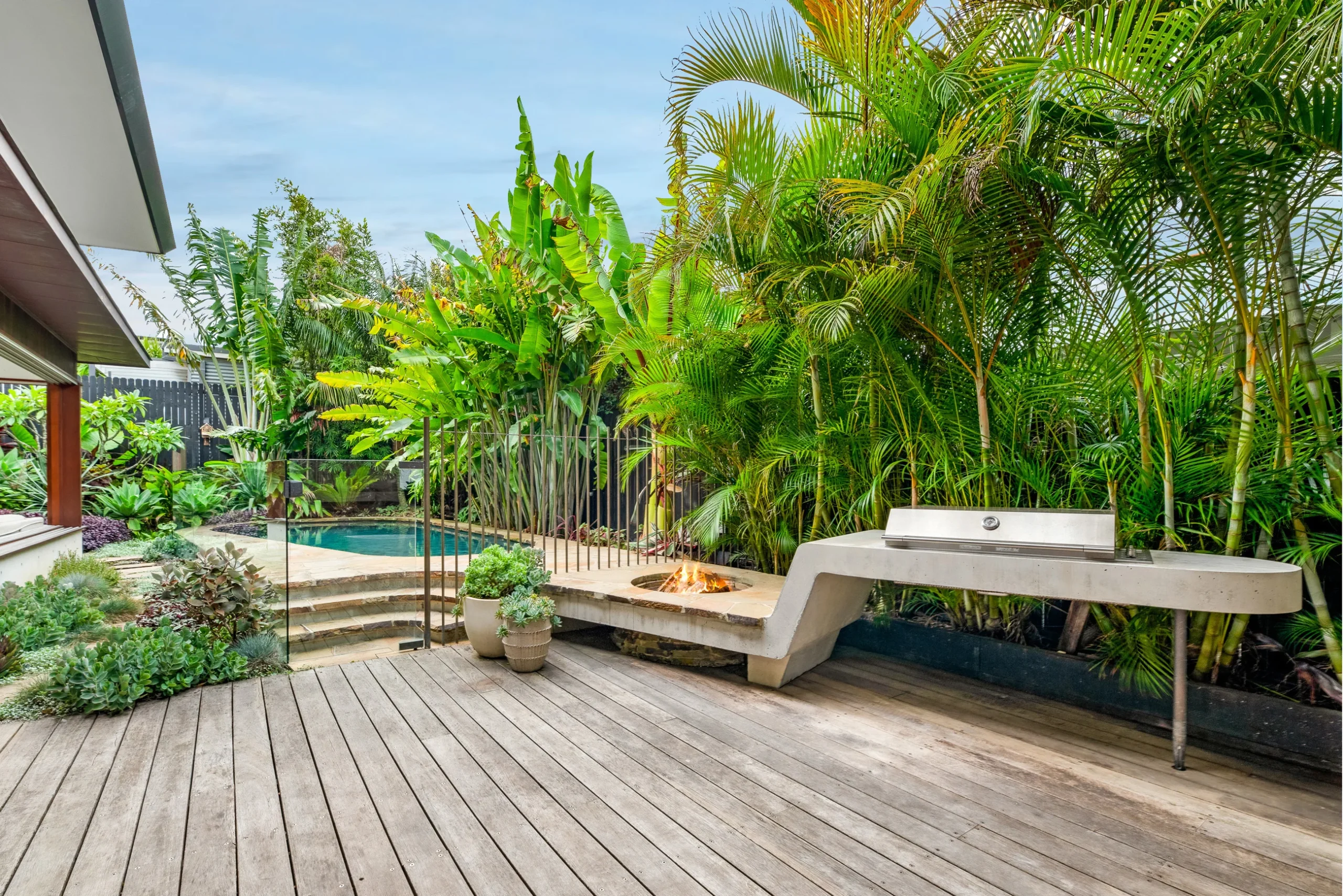 Barbecue, pool, and fire pit of a property in Avalon Beach, Sydney designed by Northern Rivers architects Markham Lee.