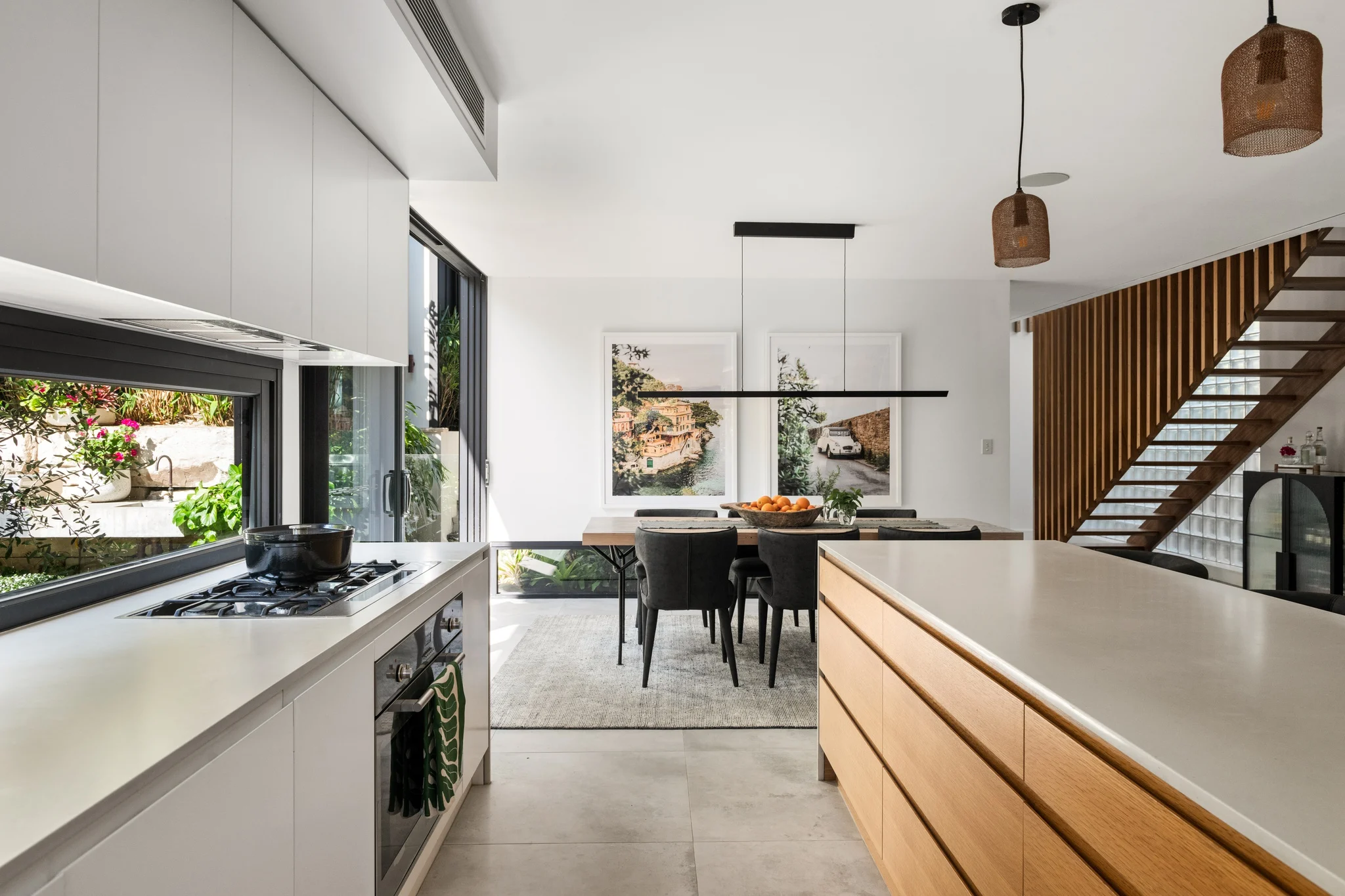Kitchen and dining room of a property in Palm Beach, Sydney designed by Avalon Beach architects Markham Lee.
