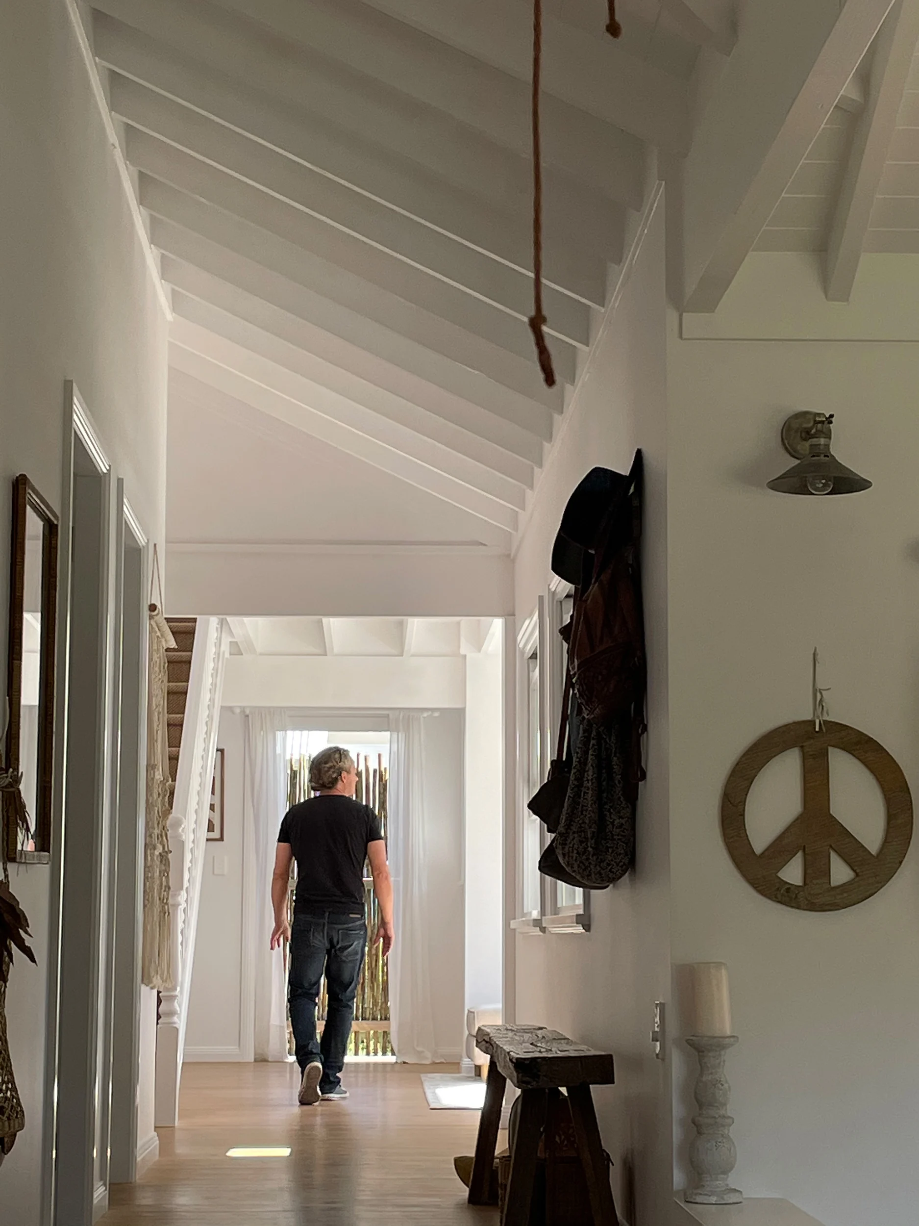 Person walking through the interior of a property in Avalon Beach, Sydney designed by Ballina architects Markham Lee.