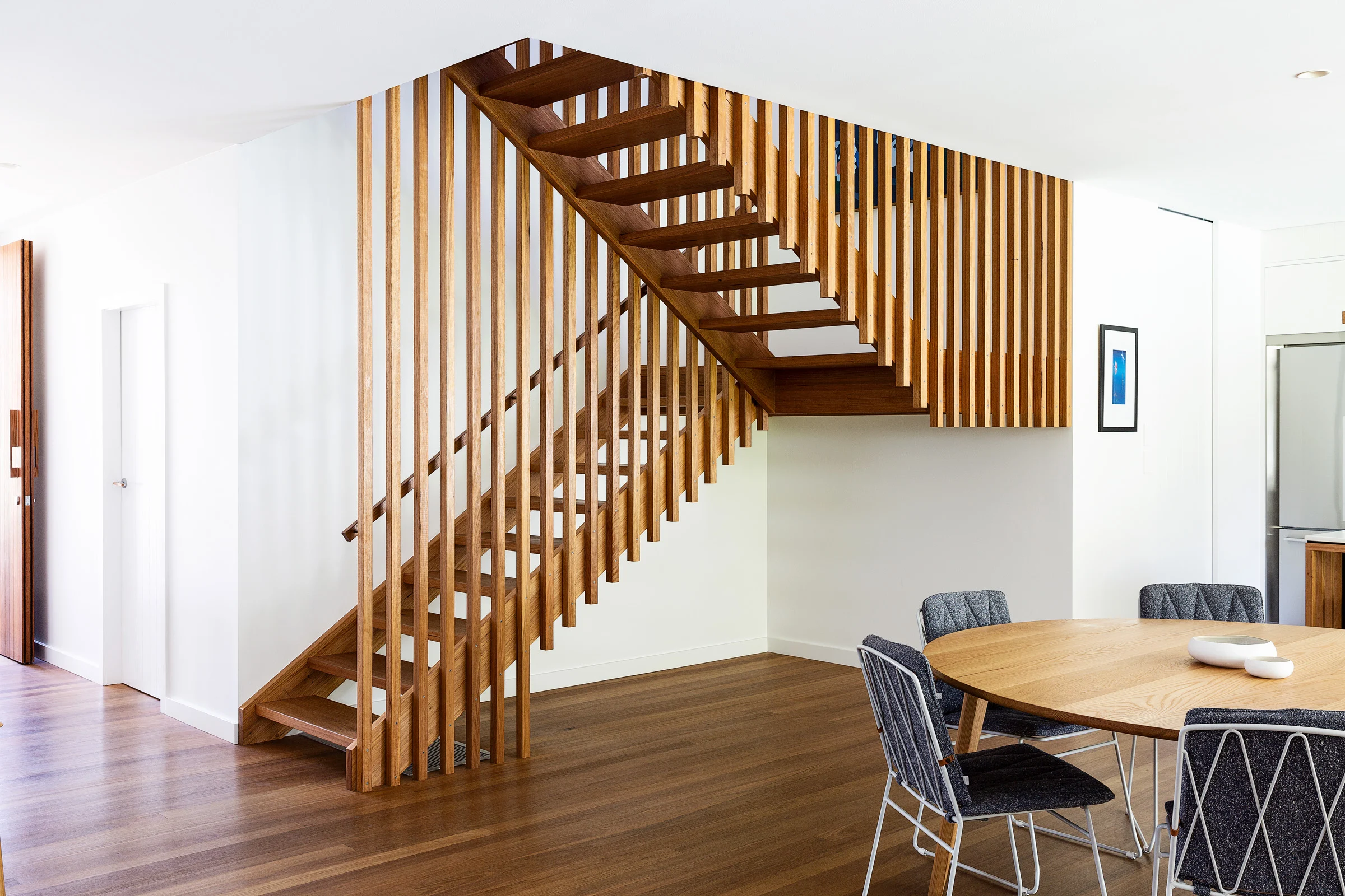 Dining room and staircase of a property in Avalon Beach, Sydney designed by Byron Bay architects Markham Lee.
